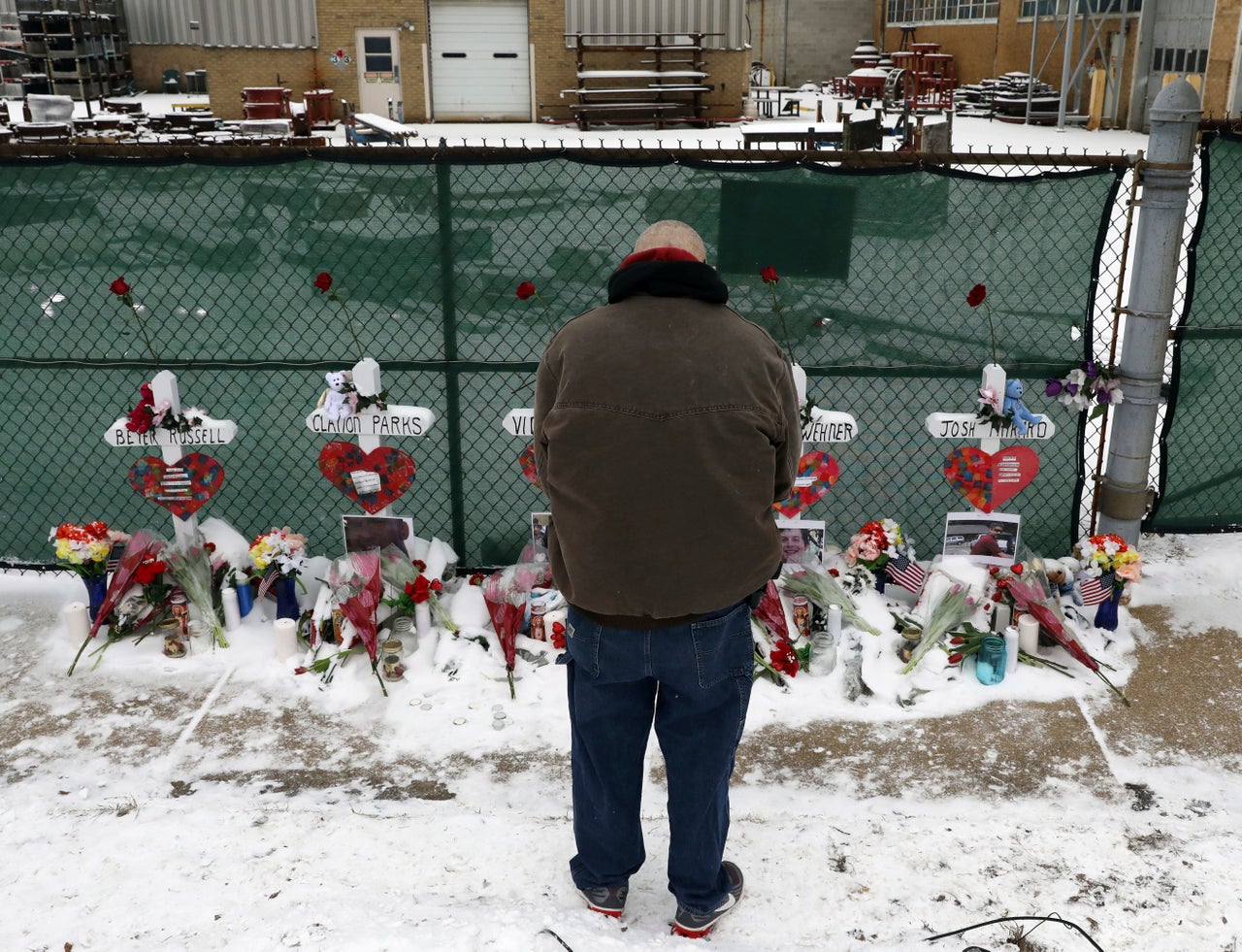 A man pays his respects at a makeshift memorial in Aurora, Illinois, near the Henry Pratt manufacturing company, where a gunman killed five people on Feb. 15. It was the 39th mass shooting in the U.S. this year.