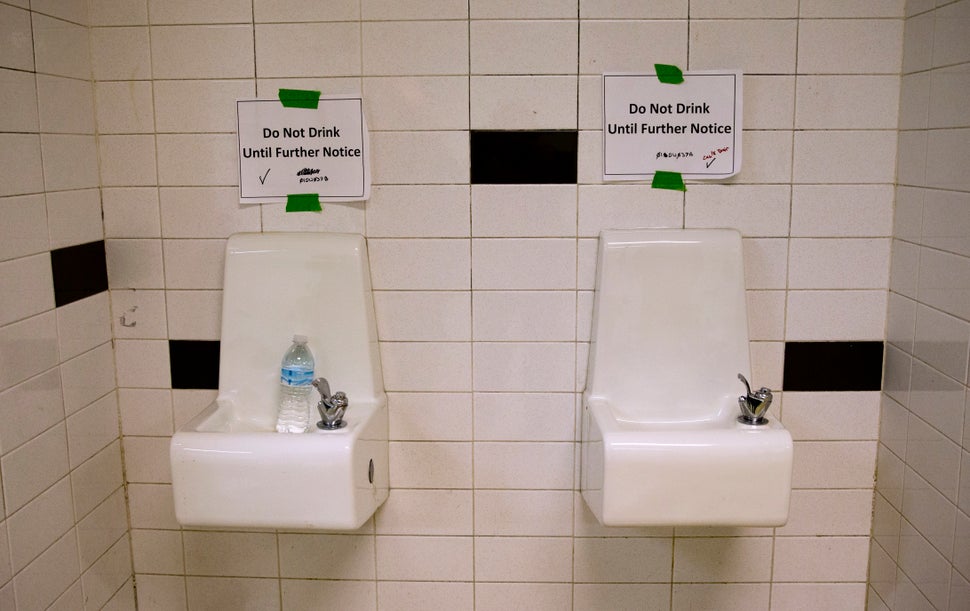 Water fountains with signs warning against drinking from them at a high school in Flint, Michigan, in May 2016. In 2014 the c