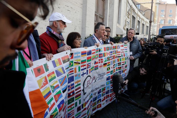 Sex abuse survivors and members of the ECA (Ending Clergy Abuse) hold their organization banner as they talk to journalists, as some of their representatives are meeting with organizers of the summit on preventing sexual abuse at the Vatican, Wednesday, Feb. 20, 2019.