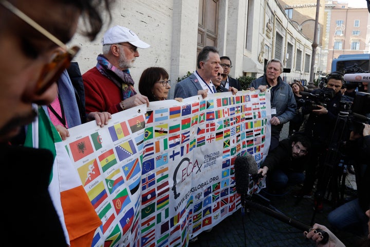 Sex abuse survivors and members of the ECA (Ending Clergy Abuse) hold their organization banner as they talk to journalists, as some of their representatives are meeting with organizers of the summit on preventing sexual abuse at the Vatican, Wednesday, Feb. 20, 2019.