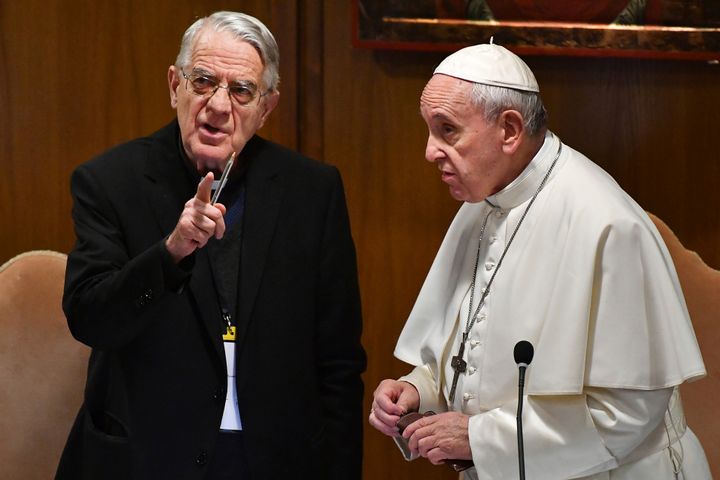 Pope Francis speaks with Rev. Federico Lombardi, left, the former Vatican spokesman who is moderating the summit.