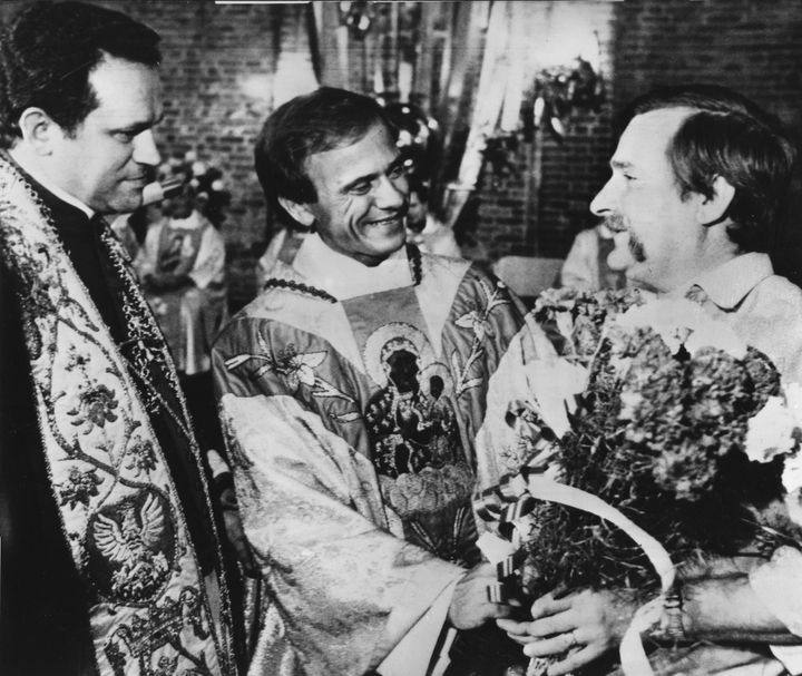 In this August 13, 1984 file photo Lech Walesa, former leader of Poland's Solidarity movement, right, speaks with priest Jerzy Popieliszko from Warsaw, and priest Henryk Jankowski, left, Walesa's personal spiritual consultant, after a holy mass at the St. Brigida church in Gdansk, Poland. 