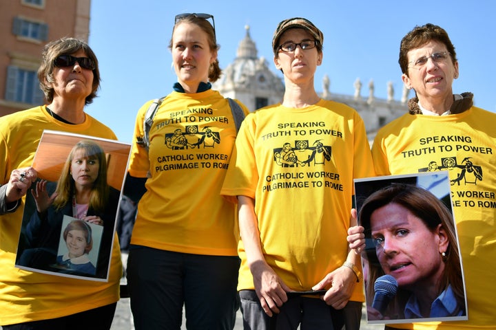 Members of Ending Clergy Abuse, a global organization of survivors and activists, display photos of Barbara Blaine, the late