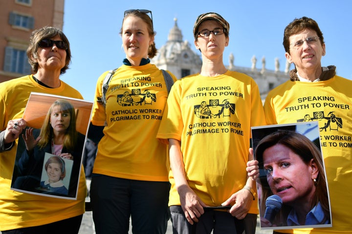 Members of Ending Clergy Abuse, a global organization of survivors and activists, display photos of Barbara Blaine, the late founder and president of Survivors Network of Those Abused by Priests, at an action in Rome during this week's papal summit, Feb. 21.