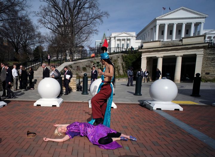 Two Equal Rights Amendment supporters, Michelle Sutherland and Natalie White, recreate the flag of Virginia outside the state Capitol in Richmond on Monday.