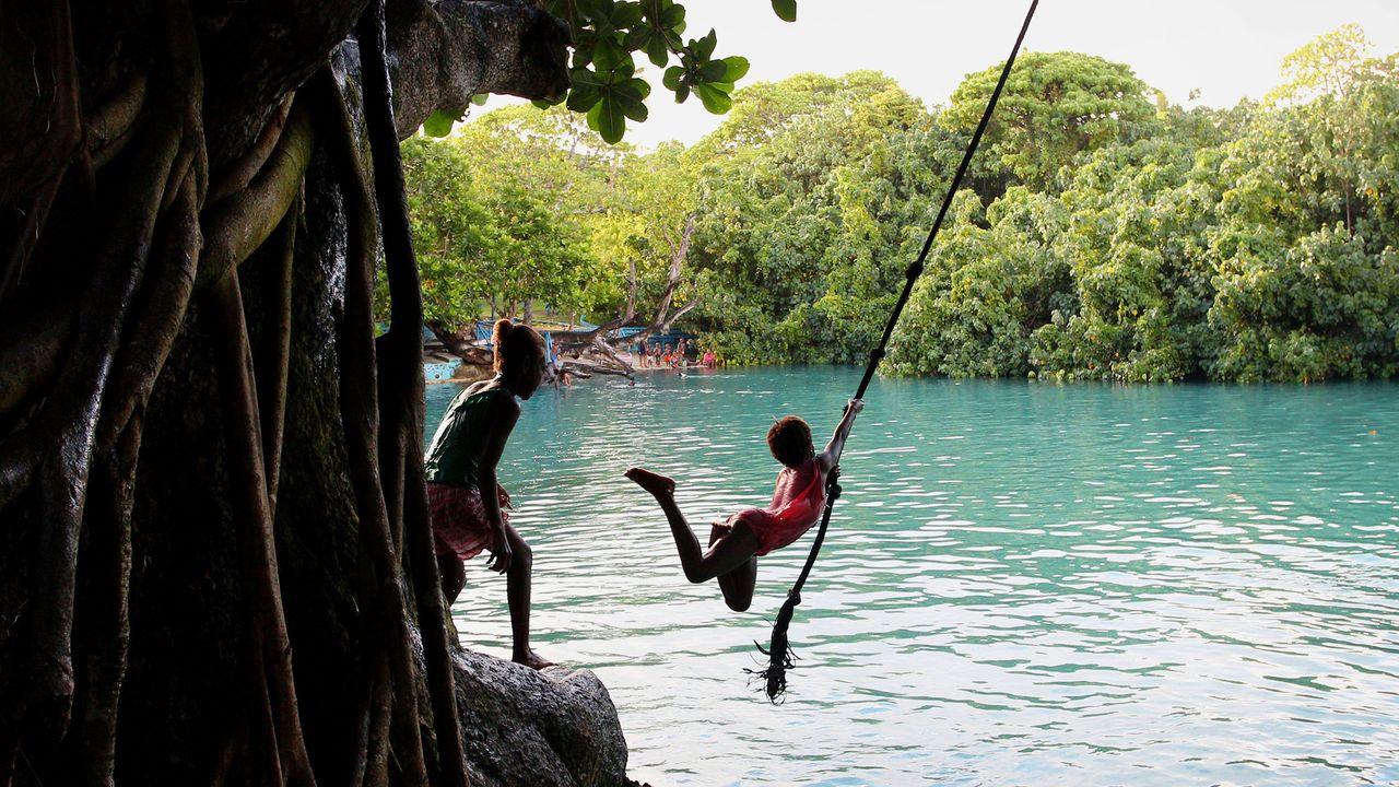 Young local children play at the Blue Lagoon swimming hole in Efate, Vanuatu. The island nation banned single-use plastic bags, straws and polystyrene food containers last year, in an effort to safeguard ocean health and cut back on urban pollution.