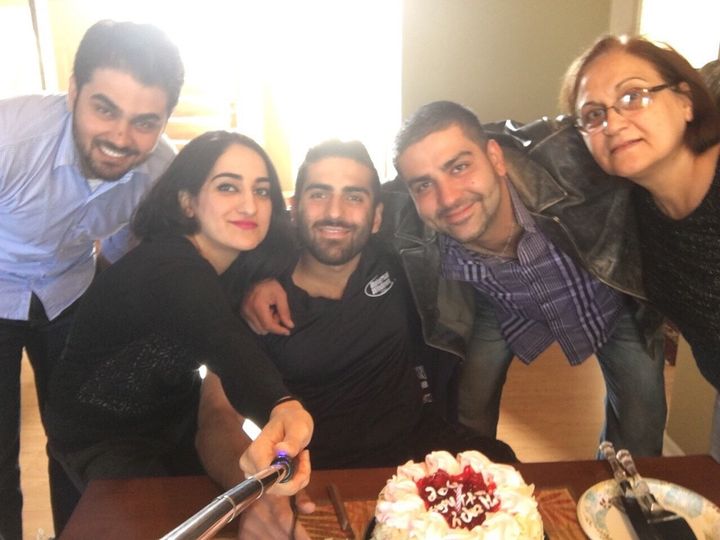 Mustafa Ayoubi (second from the right) and family pose for a photo. His sister Zahra is holding the selfie stick.