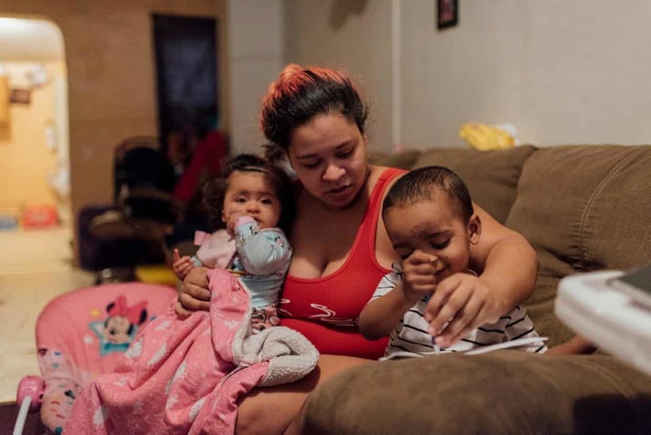Ashley Melecio, center, sits with her daughter Da’miaa Morales, left, and her son Da’ahmeer Melecio-Martinez at h