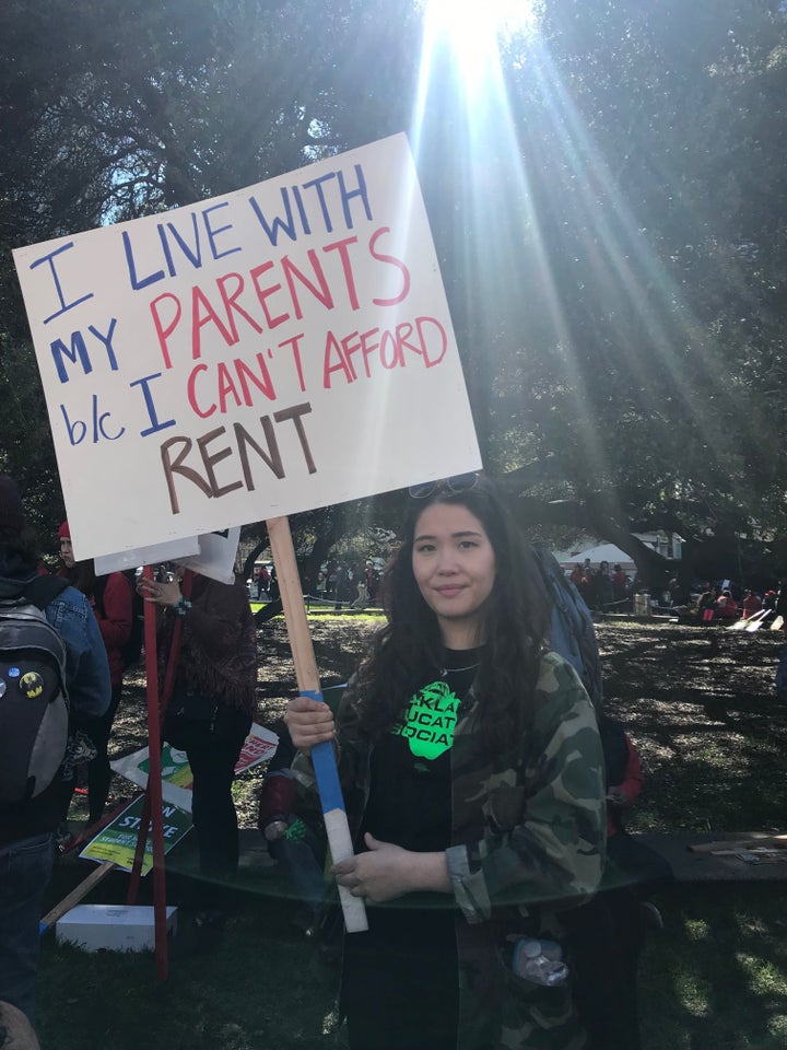 Laura Jetter, a sixth- to eighth-grade teacher at La Escuelita, holds a sign at the rally: “I live with my parents because I can’t afford rent” -- Feb. 21, Oakland, Calif.