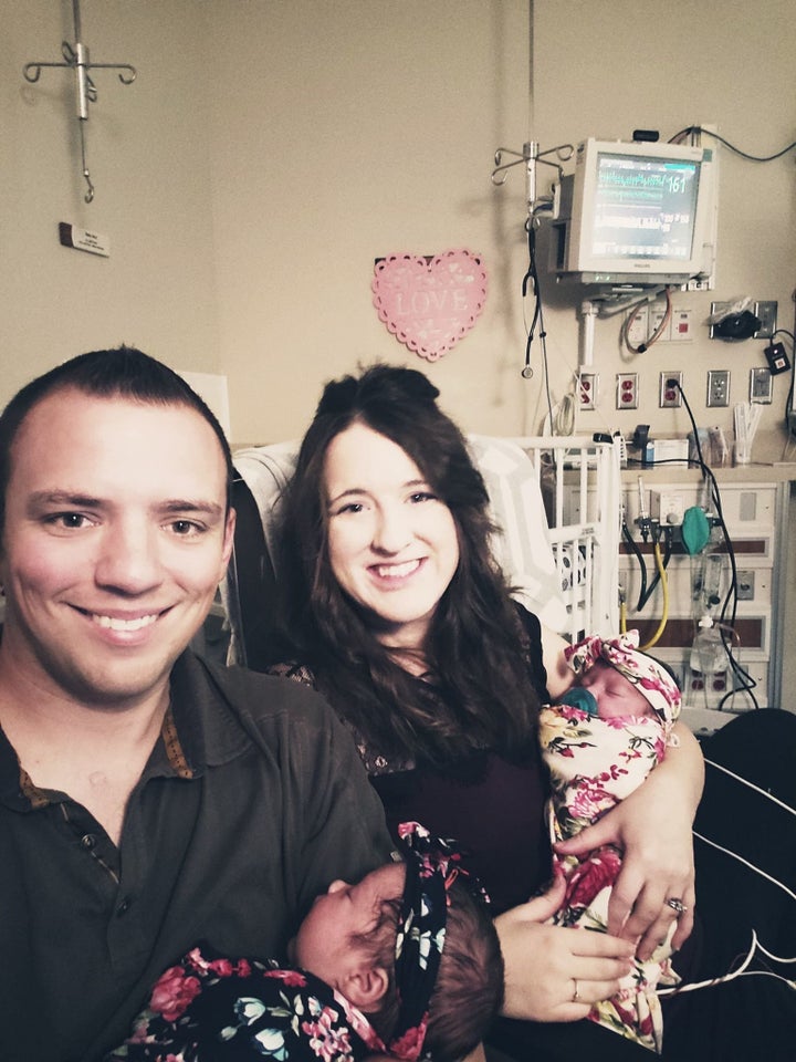 Reunited and it feels so good! The Coopers holding their newborn daughters.