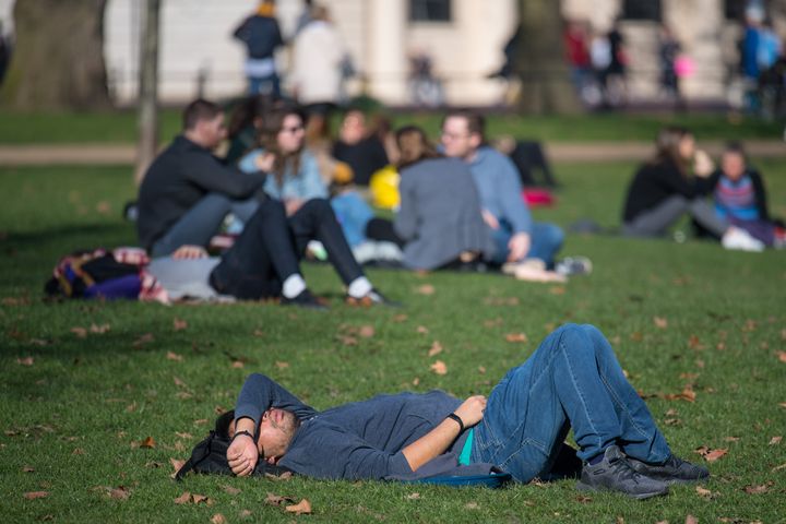 People sit in the sun in London's St James's Park on Saturday.