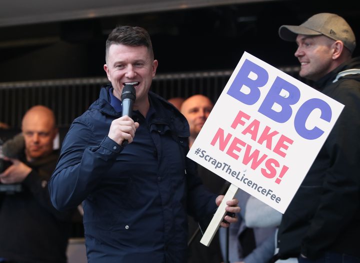 Robinson appeared on stage carrying a placard criticising the BBC.