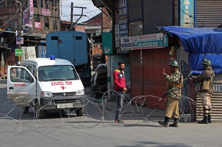 Paramilitary soldiers stop an ambulance driver during restrictions in old city Srinagar, Kashmir on February 24, 2019.
