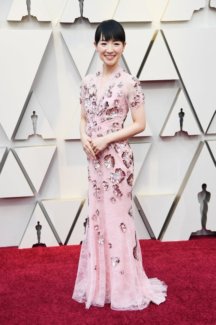 Kondo wore a pink gown with sequined flowers and lace embellishments by Jenny Packham.