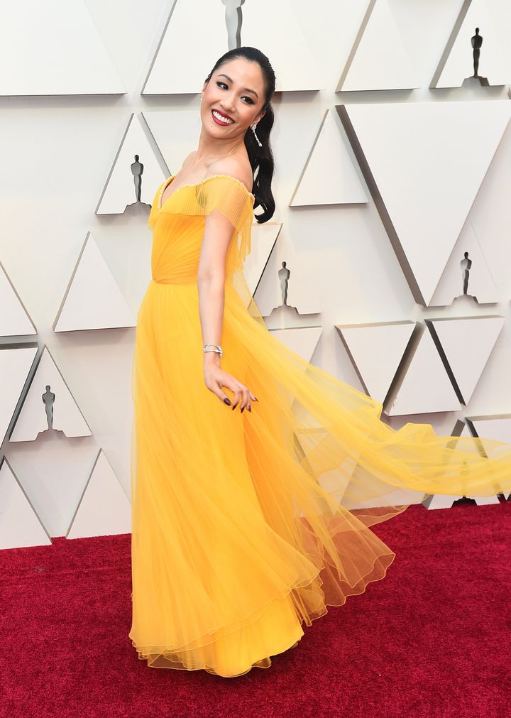 Constance Wu in a custom, bold yellow Versace gown.