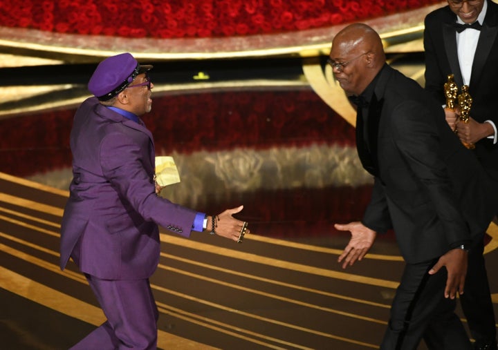 Spike Lee accepts the Adapted Screenplay award for 'BlacKkKlansman' from Samuel L. Jackson onstage during the 91st Annual Aca