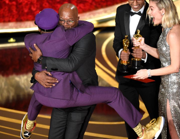Samuel L. Jackson, center left, embraces Spike Lee, winner of the award for best adapted screenplay for "BlacKkKlansman" as Brie Larson looks on, at the Oscars on Sunday, Feb. 24, 2019, at the Dolby Theatre in Los Angeles. (Photo by Chris Pizzello/Invision/AP)