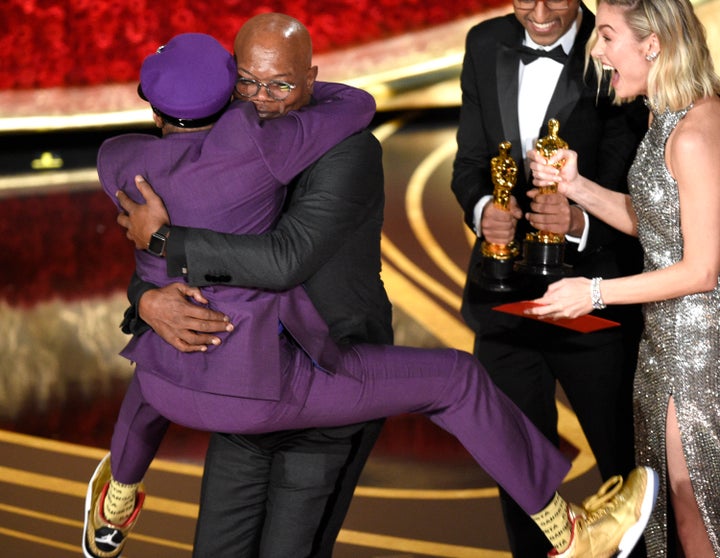 Samuel L. Jackson, center left, embraces Spike Lee, winner of the award for best adapted screenplay for "BlacKkKlansman" as B