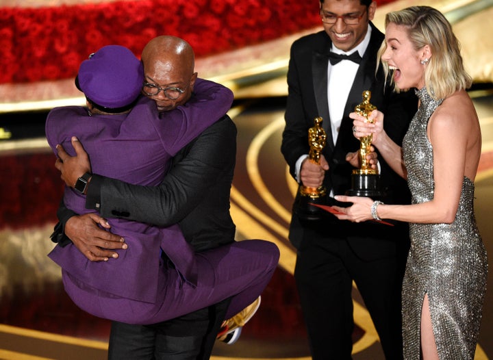 Spike Lee jumps on friend and Oscars presenter Samuel L. Jackson after receiving his first Oscar win on Sunday, February 24, 2019.