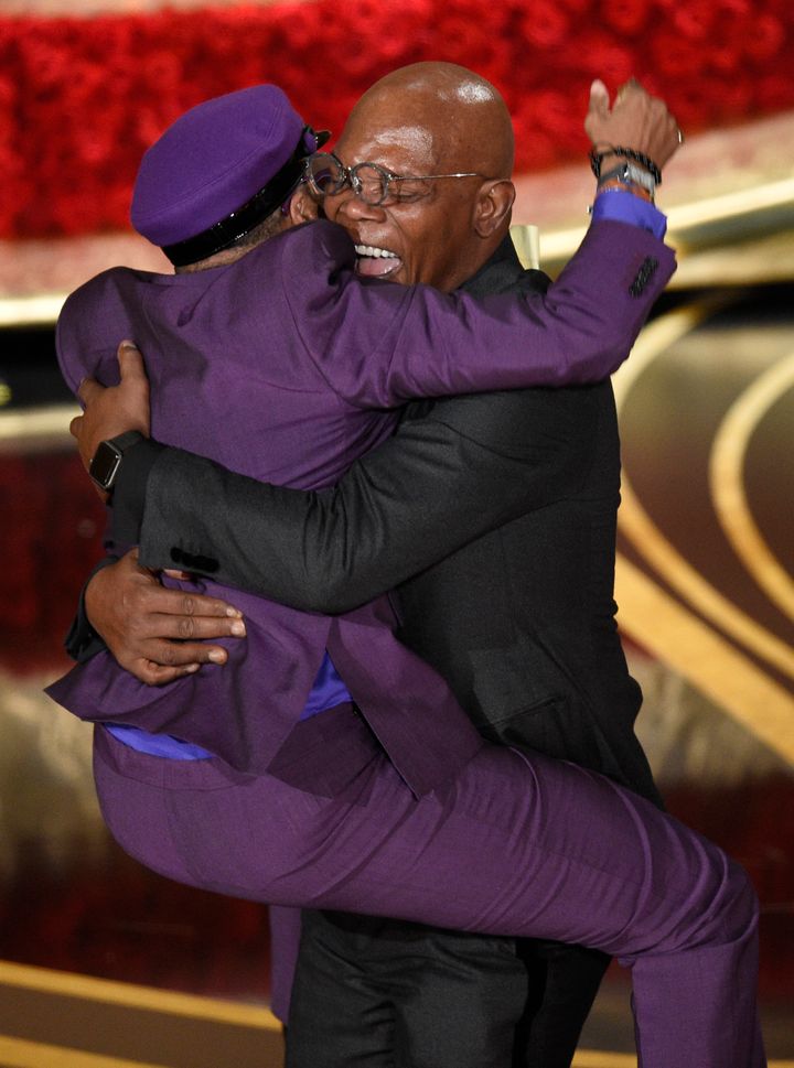 Spike Lee jumps on friend and Oscars presenter Samuel L. Jackson after receiving his first Oscar win on Sunday, February 24, 2019.