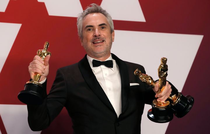 "Roma" director Alfonso Cuarón poses with his three Oscars Sunday night.