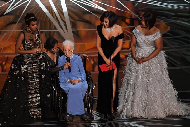 NASA mathematician Katherine Johnson (center) is accompanied by actresses Janelle Monae (left), Taraji P. Henson (second from right) and Octavia Spencer (right) as they present onstage at the 89th Oscars on February 26, 2017, in Hollywood, California.