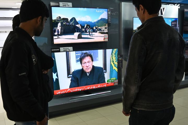 Pakistani people watch the television as Prime Minister Imran Khan speaks to the nation about the suicide bombing in Pulwama, on 19 February 2019. 