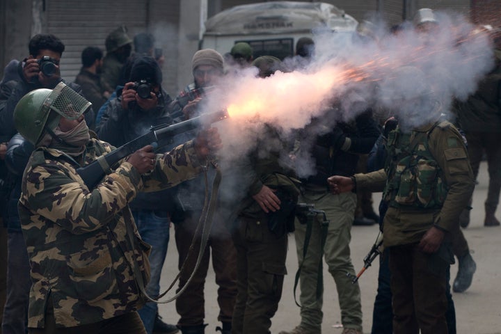 An Indian paramilitary solider fires tear gas shell towards Kashmiri protesters in Srinagar, Indian controlled Kashmir, Tuesday, Feb. 26, 2019.