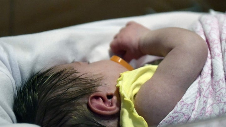 A week-old baby lies in a bay in the neonatal intensive care unit at the Norton Children’s Hospital in Louisville, Kentucky.