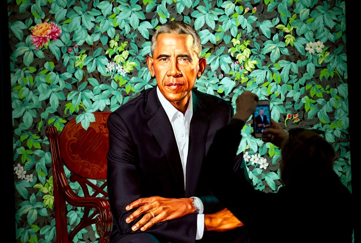 A visitor takes picture of the official portrait of the former President Barack Obama in the first day open exhibit at the Sm
