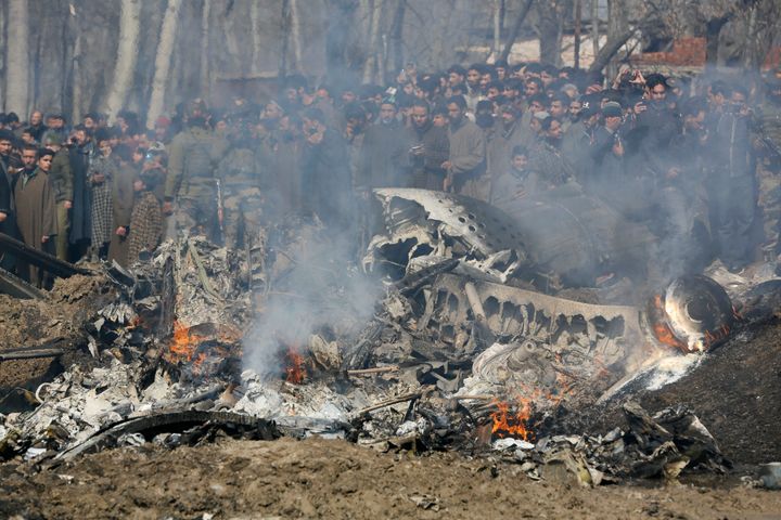 Kashmiri villagers gather near the wreckage of an Indian aircraft after it crashed in Budgam area, outskirts of Srinagar, Indian controlled Kashmir on Wednesday.