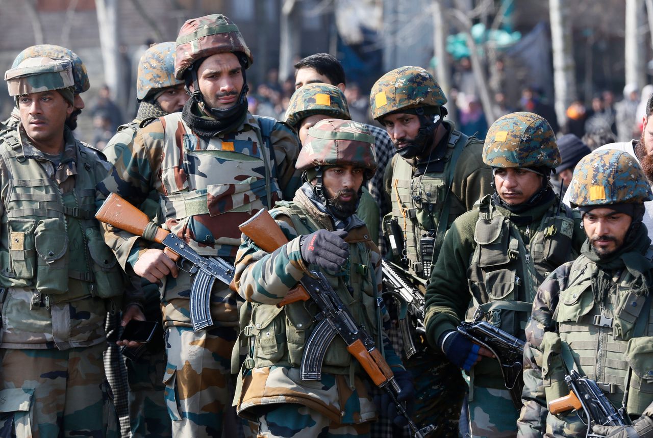 Indian army soldiers stand near the wreckage of an Indian aircraft after it crashed in Budgam area, outskirts of Srinagar, Indian controlled Kashmir, Wednesday, Feb.27, 2019.