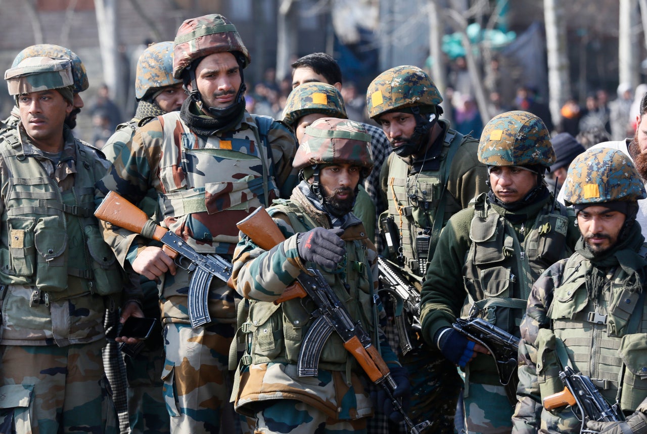 Indian army soldiers stand near the wreckage of an Indian aircraft after it crashed in Budgam area, outskirts of Srinagar, Indian controlled Kashmir, Wednesday, Feb.27, 2019.