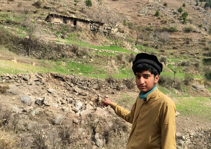 A resident points to the damaged site where Indian military aircrafts released payload in Jaba village, Balakot, Pakistan.