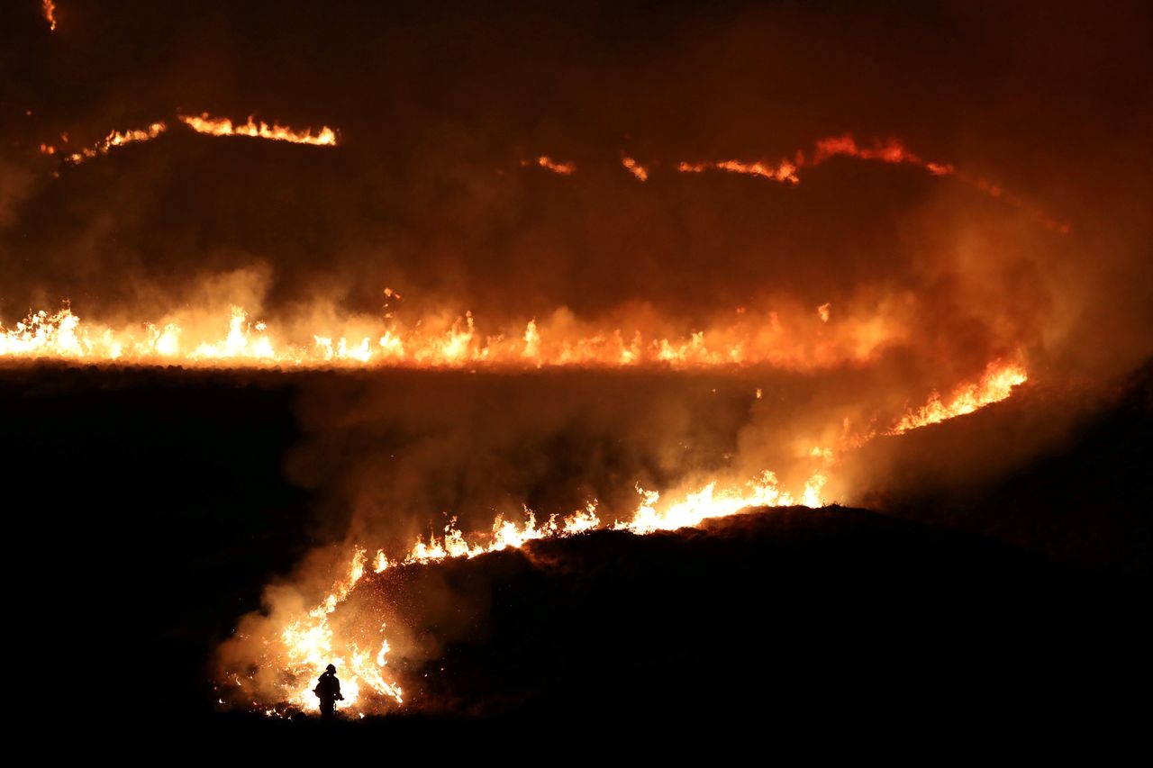 A fire is seen burning on Saddleworth Moor near the town of Diggle, England, Feb. 27, 2019.