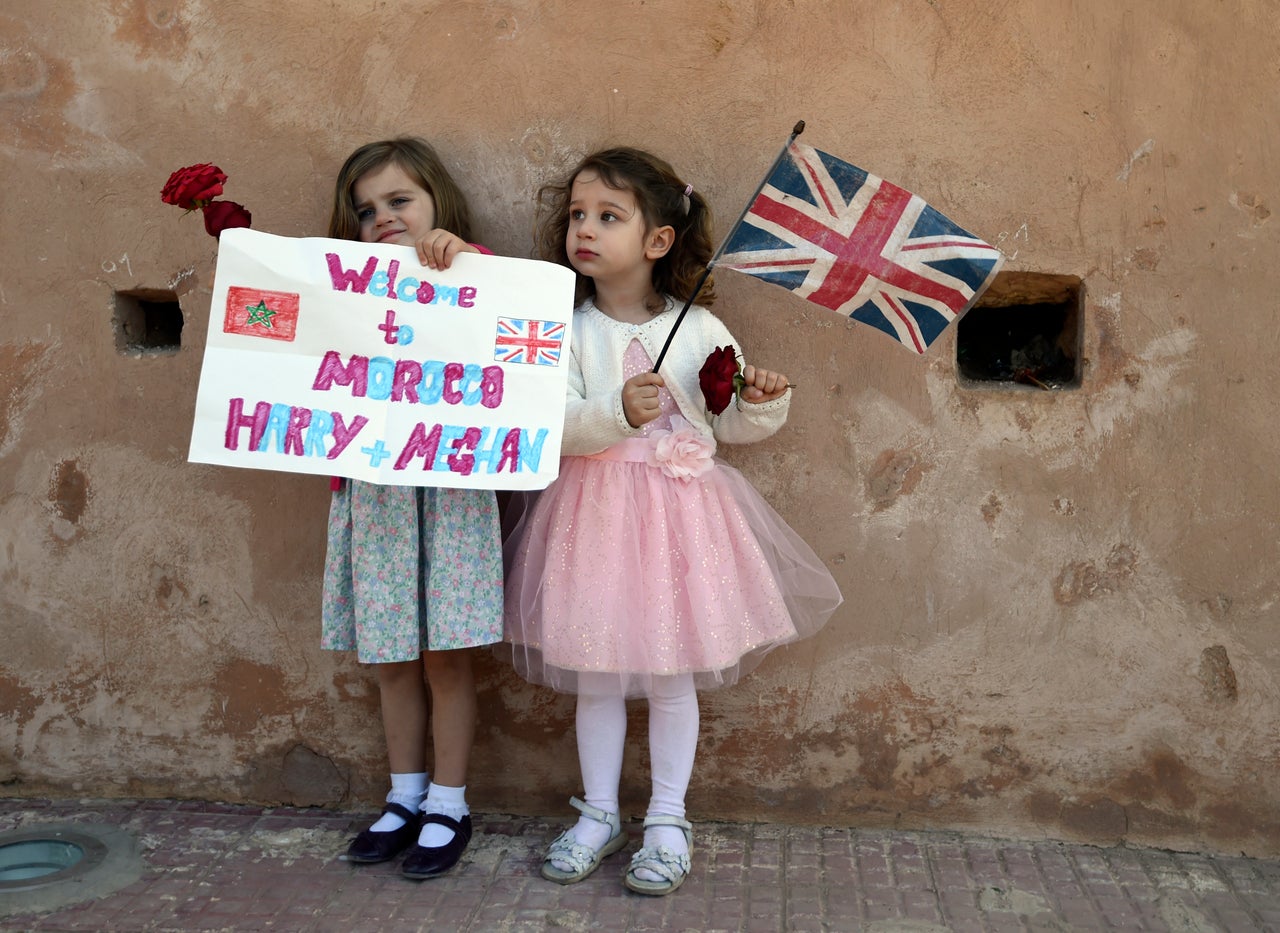 Children wait for the arrival of Britain's Prince Harry and Meghan, Duchess of Sussex, at the Andalusian Gardens in Rabat, Morocco, on Feb. 25, 2019.