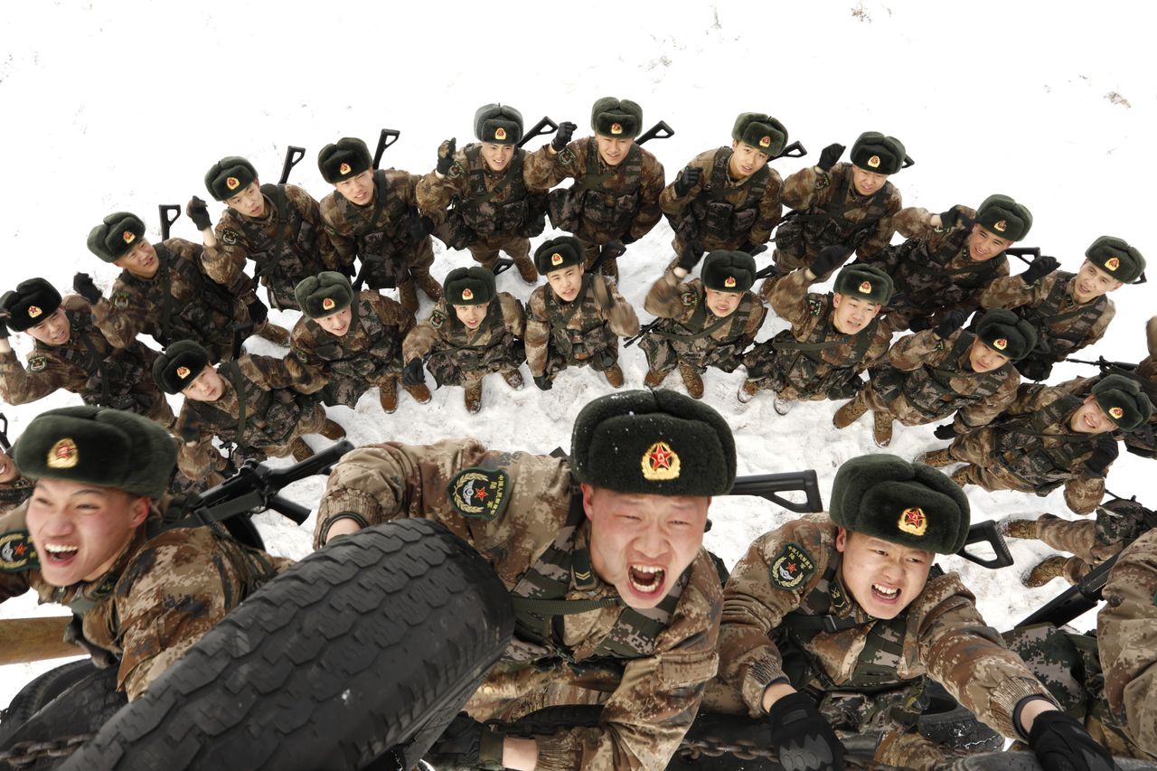 Frontier soldiers climb a tire-wall in a drill on Feb. 27, 2019, in Heihe, China.