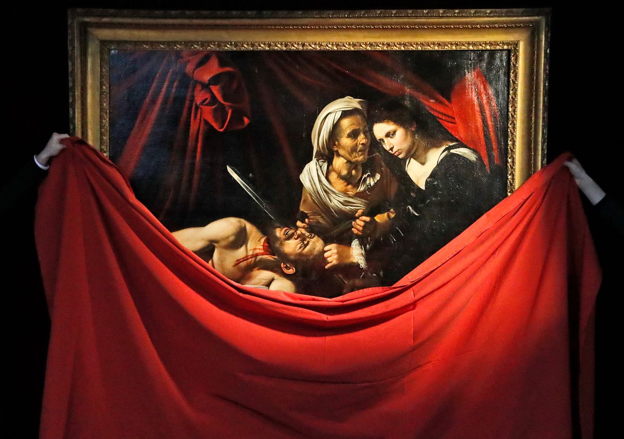 The Caravaggio "Judith and Holofernes" painting is unveiled at the Colnaghi Gallery in London, on Feb. 28, 2019. The painting, lost in Amsterdam in 1617, was rediscovered in an attic in a Toulouse farmhouse in 2014.