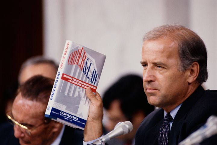 Joe Biden, then chairman of the Senate Judiciary Committee, holds up the book <em>Order and Law</em> by Charles Fried during the Clarence Thomas hearings.