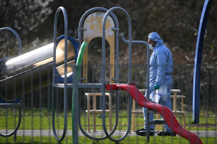 Police officers search near the scene on St Neot's Road in Harold Hill, east London following the fatal stabbing of a 17-year-old girl on Friday night.