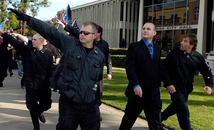 2011 file photo— Jeff Schoep is second from the right, in a suit,.
