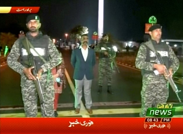 Indian pilot, Wing Commander Abhinandan, stands under armed escort near Pakistan-India border in Wagah,...