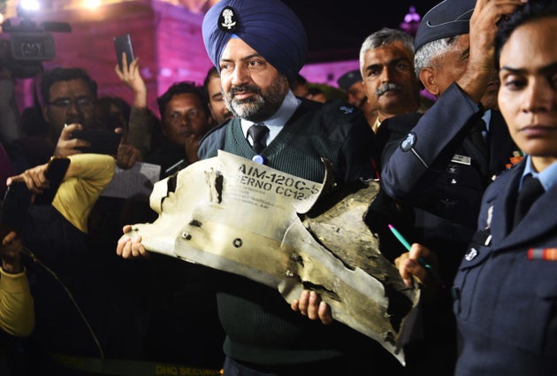  Indian Air Force officials show sections of an exploded AMRAAM missile, said to be fired by Pakistan...