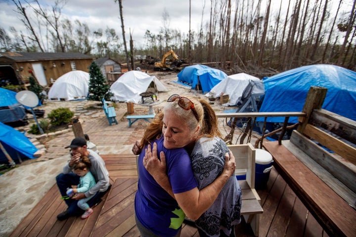 Diahnn "Shelly" Summers, right, embraces Lori Hogan, who is currently living in a tent in Summers' backyard months after Hurr