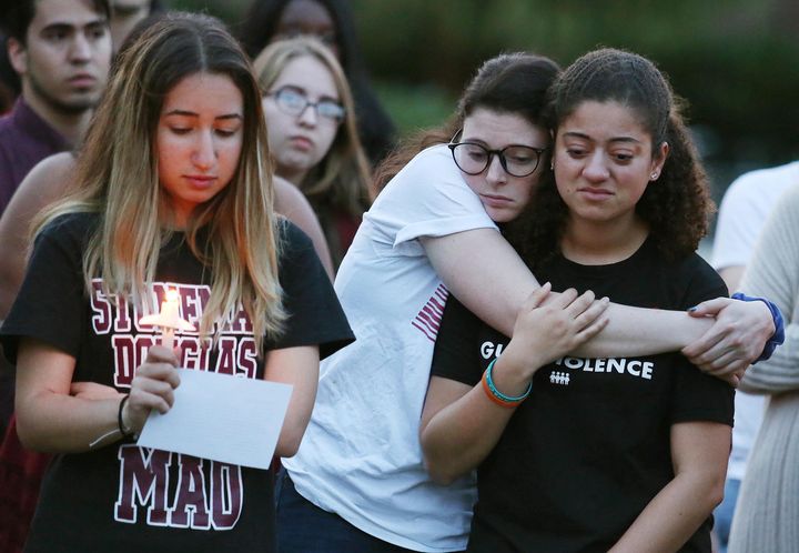 Students grieve during a candlelight vigil in commemoration of the one-year anniversary of the mass shooting at Marjory Stoneman Douglas High School. The federal government and some state legislatures have pushed for enhanced security at schools in the wake of the shooting. 