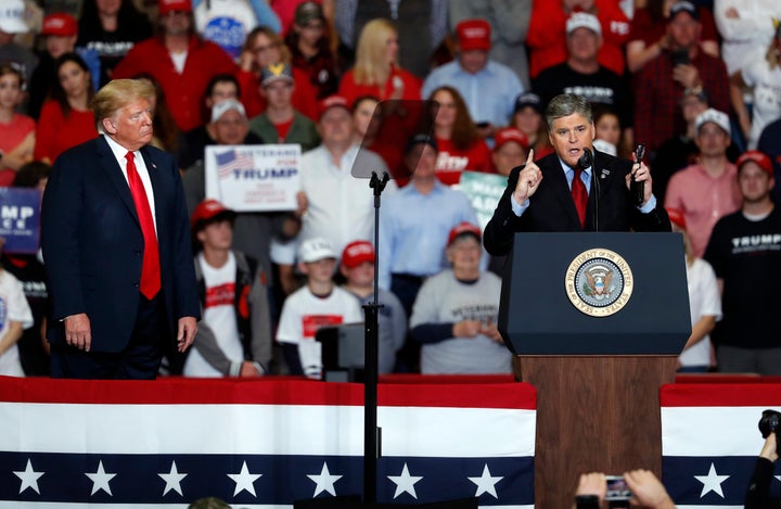 Television personality Sean Hannity, right, speaks as President Donald Trump listens during a campaign rally Monday, Nov. 5, 2018, in Cape Girardeau, Missouri.