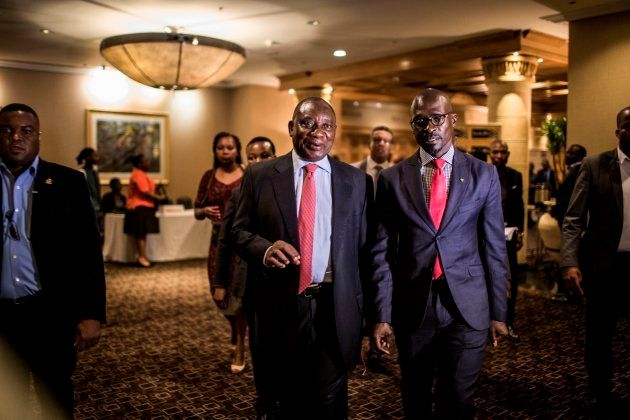 Deputy President of South Africa, and newly elected African National Congress (ANC) President, Cyril Ramaphosa (C) and Minister of Finance, Malusi Gigaba (R) flanked by security and media leaves from the Pre-World Economic Forum (WEF) Breakfast, which takes place ahead of the WEF Annual meetings in Davos, at the Hilton Hotel in Sandton district of Johannesburg on January 18, 2018. / AFP PHOTO / GULSHAN KHAN (Photo credit should read GULSHAN KHAN/AFP/Getty Images)