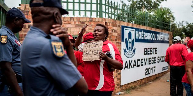A member of Sadtu faces policemen during a demonstration against the language and admission policies at Hoërskool Overvaal in Vereeniging on January 22, 2018.