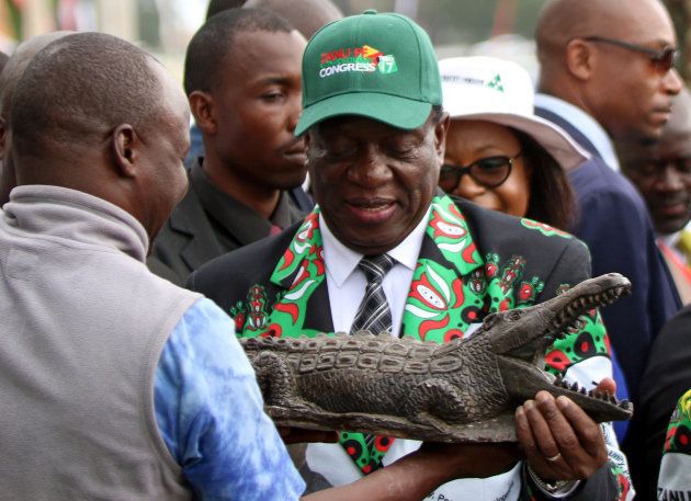 Zimbabwe?s President Emmerson Mnangagwa receives a gift after officially opening the Extraordinary Congress of the ruling party ZANU PF in Harare, Zimbabwe December 15, 2017.