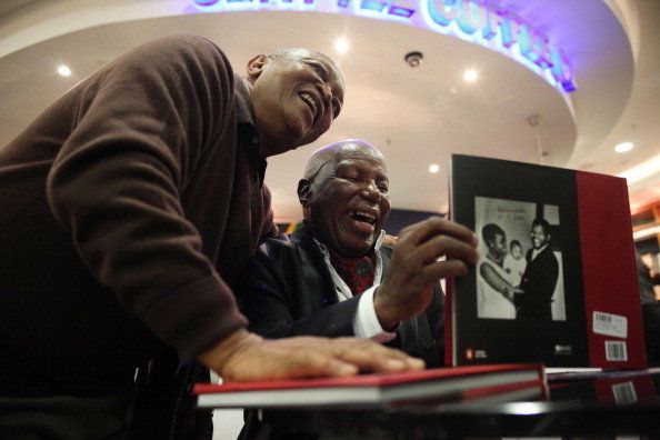 Musician Hugh Masekela (L) posing with legendary Alf Kumalo after he signed a copy of his new book 8115 at the launch of the book in 2010.